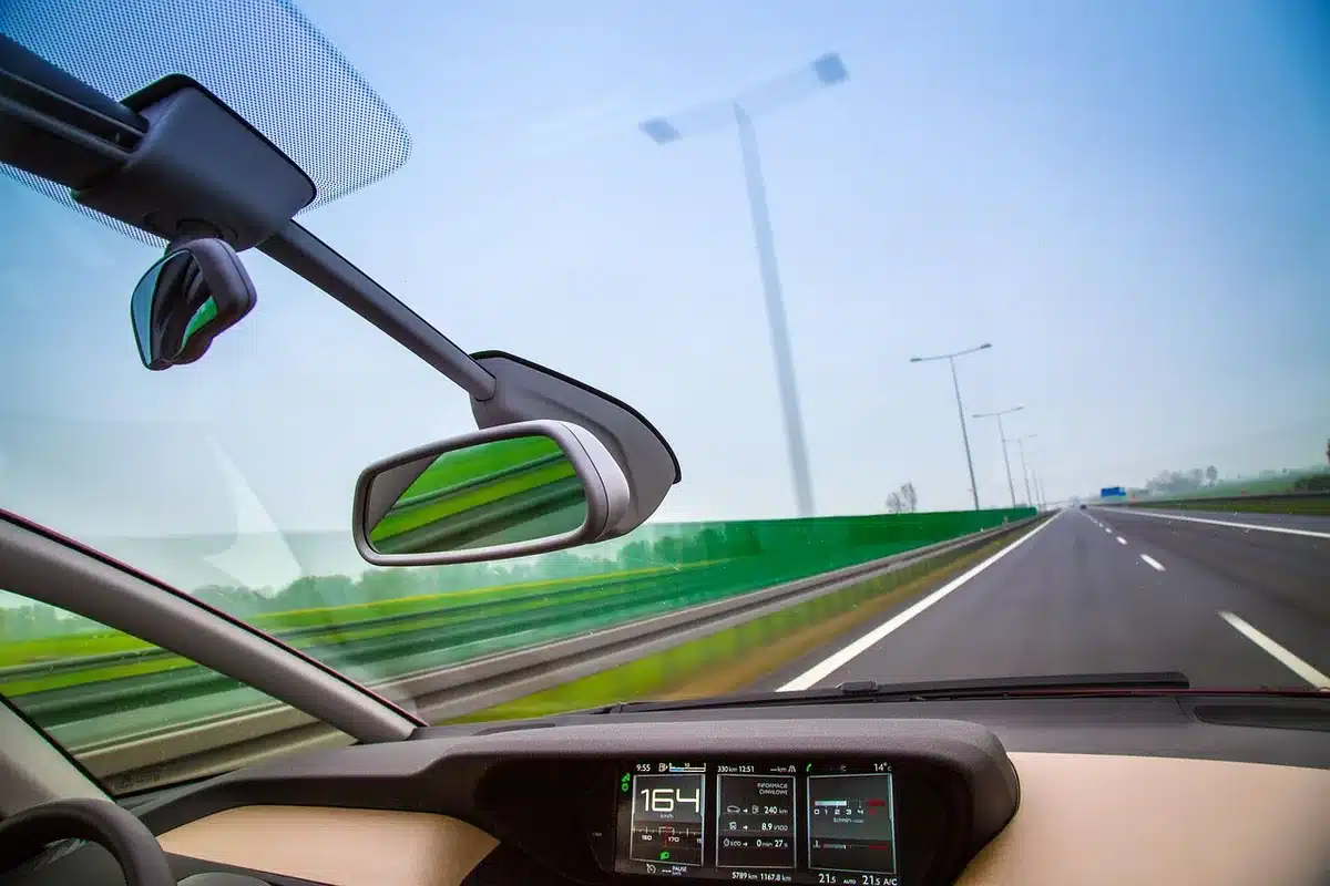 Tableau de bord et autoroute vue depuis une voiture en déplacement longue distance