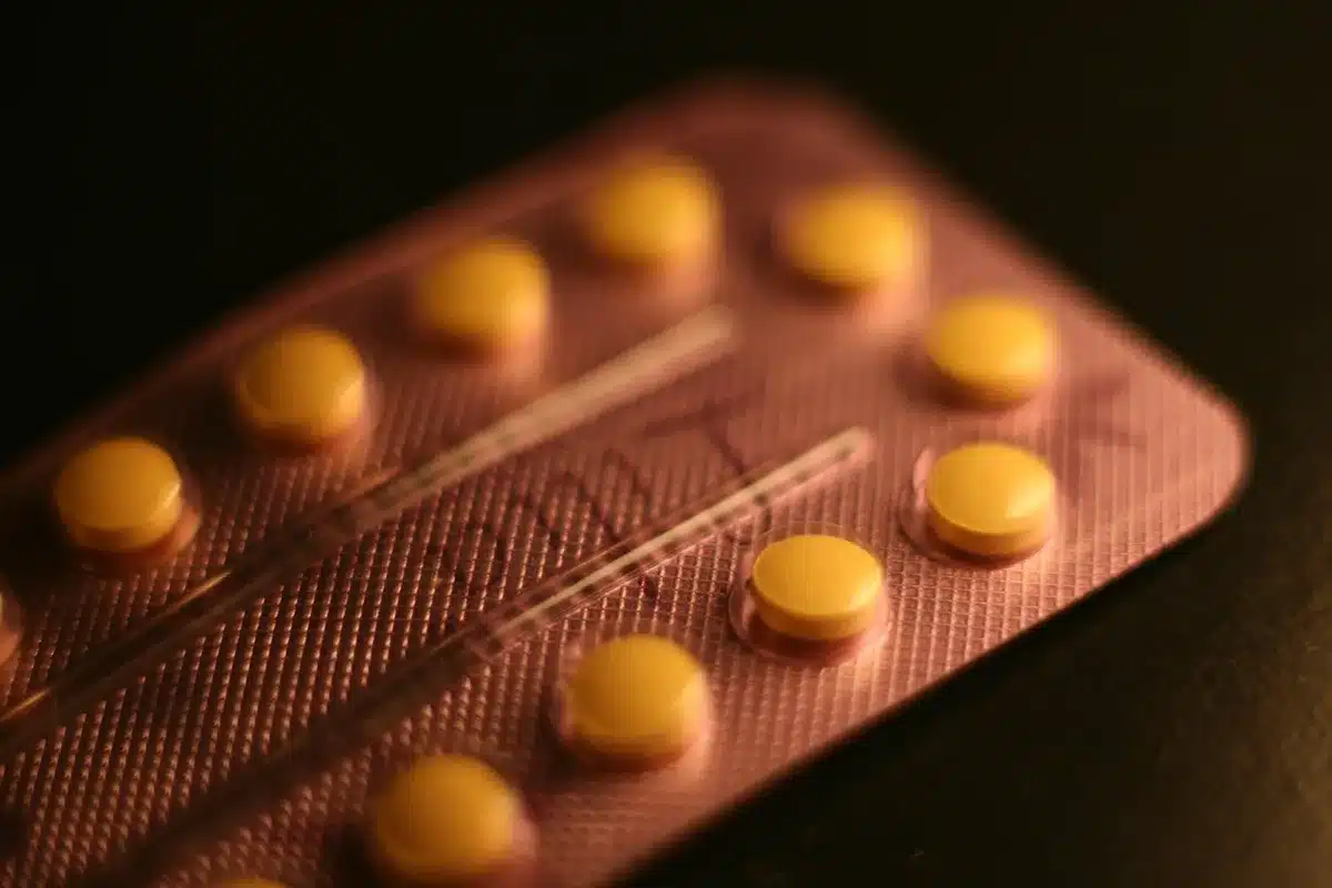 File d'attente devant une pharmacie, silhouettes et main tenant une carte vitale